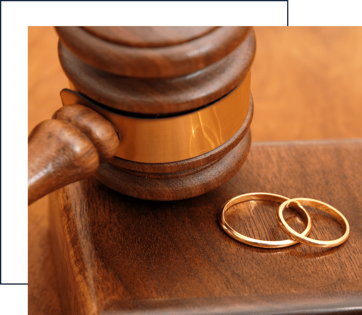Gavel and wedding rings on wooden block