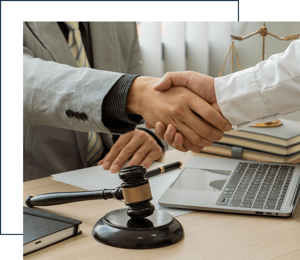 Business handshake over legal documents