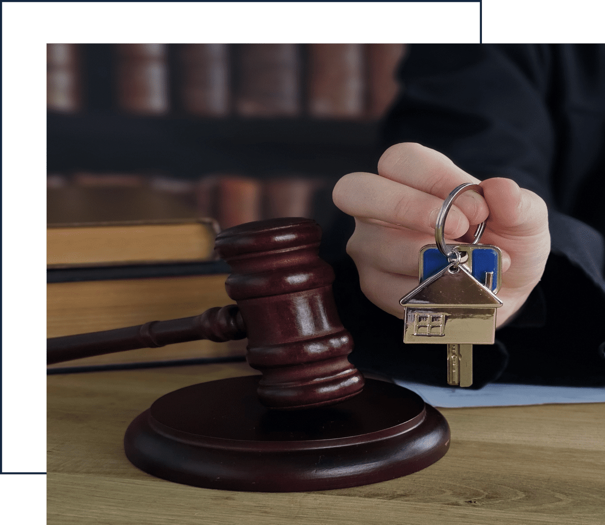 Gavel and house key on desk