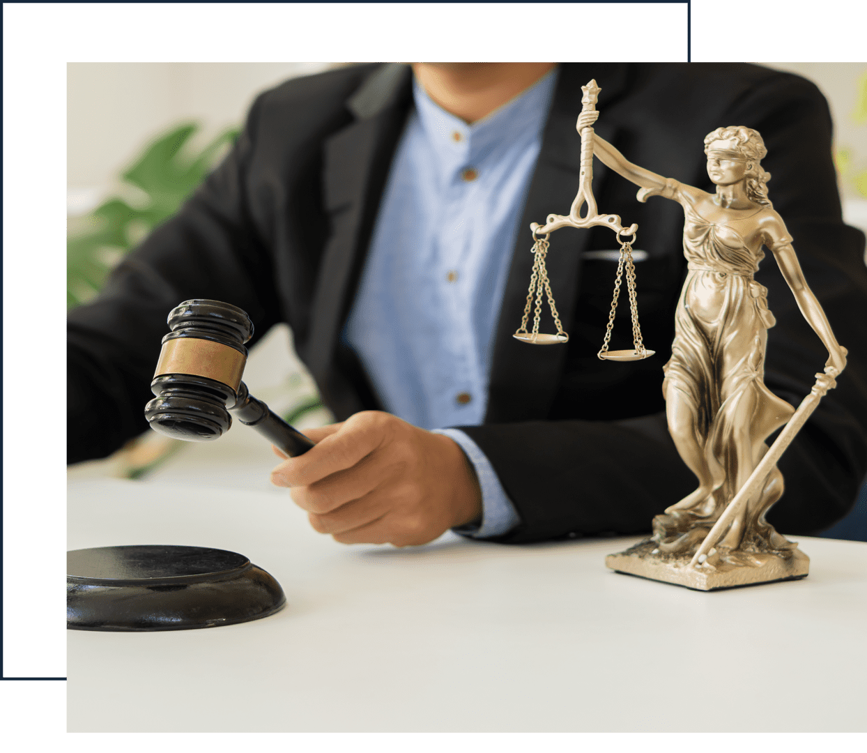 Judge with gavel and Lady Justice statue